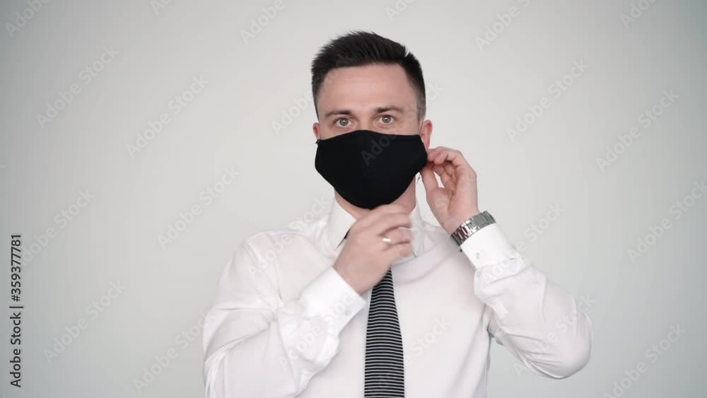 man in suit fixing protective mask preventing from coronavirus flu disease. male on white background. concept isolation, business. safety during epidemic of illness. guy person in suit portrait man in suit fixing protective mask preventing from coronavirus flu disease. male on white background. concept isolation, business. safety during epidemic of illness. guy person in suit portrait