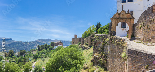 Panorama of the old city wall and surrounding mountains in Ronda, Spain © venemama