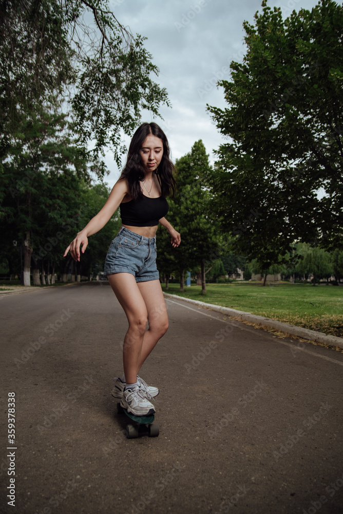 Young girl riding a skateboard in the city