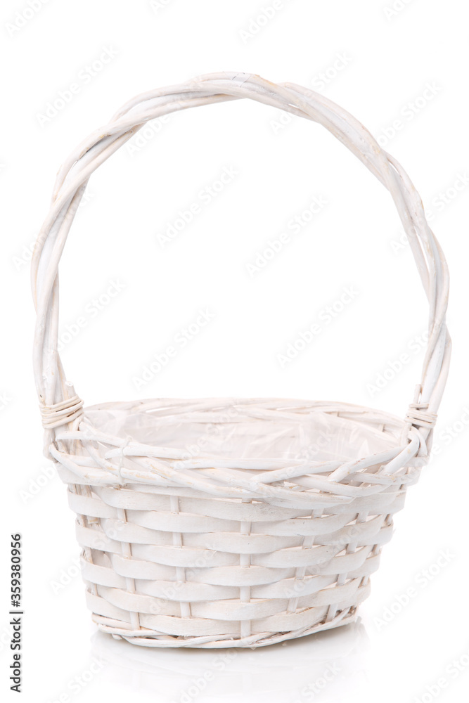 White wicker basket with high handle on a white background.