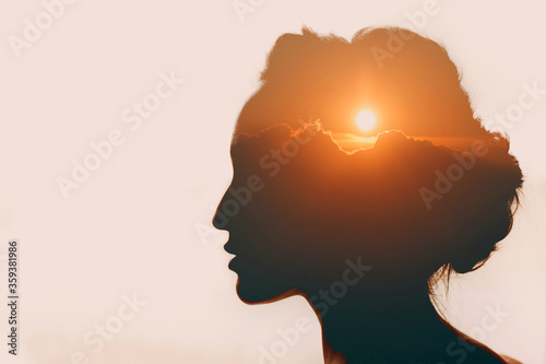 Woman with sun over clouds in her head. Mental health concept photo
