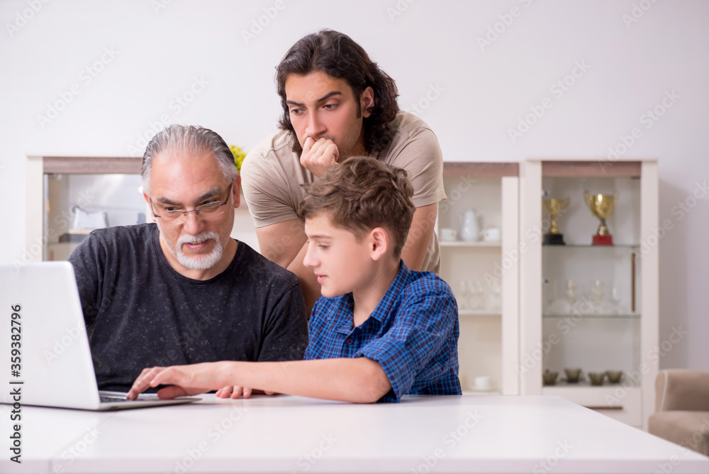 Grandfather learning new technology from son and grandson Grandfather learning new technology from son and grandson