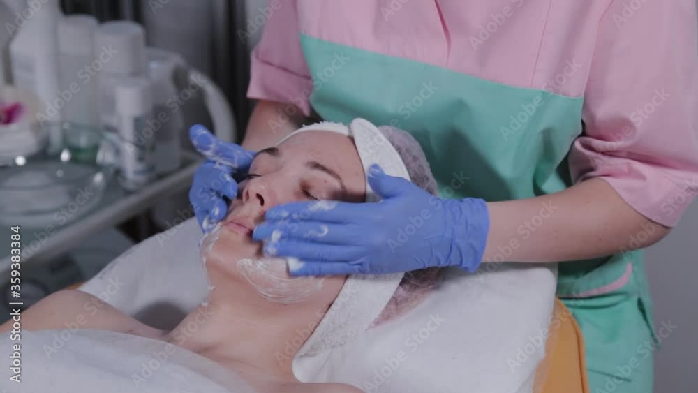 Professional beautician puts gel on gloves and rubs it. Professional beautician puts gel on gloves and rubs it.