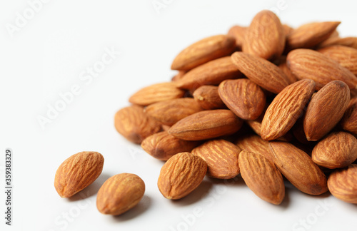 .almonds situated arbitrarily on the white background with clipping path