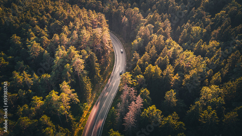Aerial picture of traveling cars on countryside road in summer in Kaunas district, Lithuania