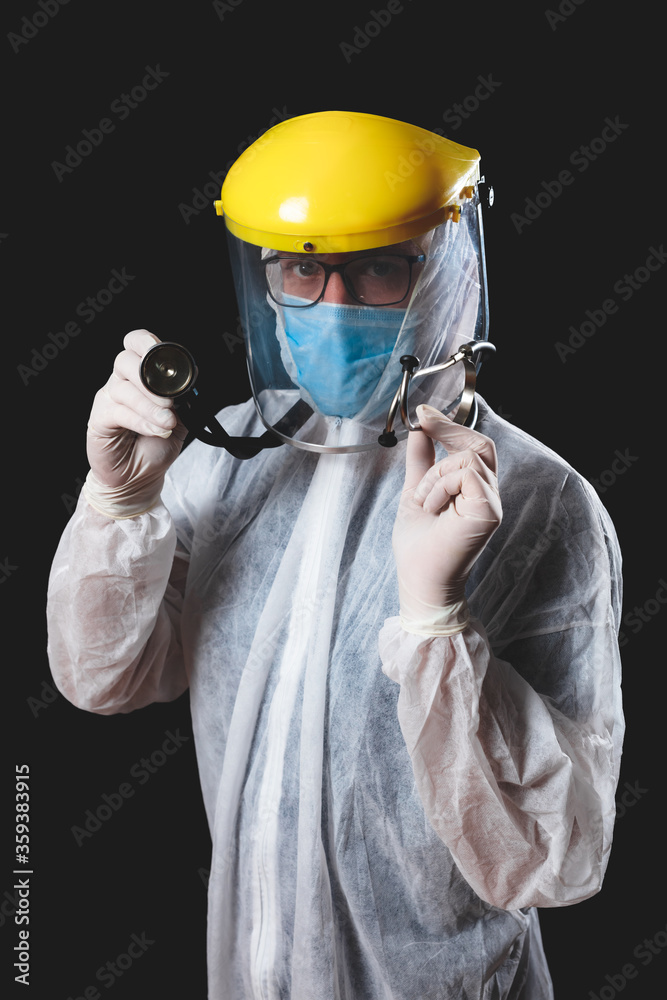 Medical doctor, nurse, surgeon, psychologist working with protective mask, glasses and gloves helping people in the days of panic, pandemic - studio shot on black background. Medical doctor, nurse, surgeon, psychologist working with protective mask, glasses and gloves helping people in the days of panic, pandemic - studio shot on black background.
