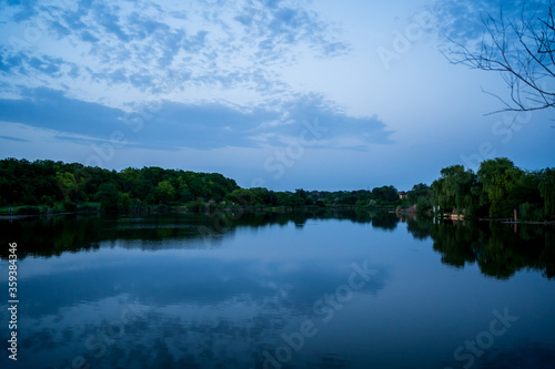 beautiful evening landscape. sunset on river. calm water in pond.