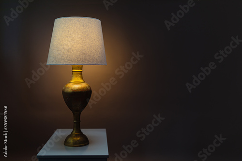 Vase-lamp on the grey table.