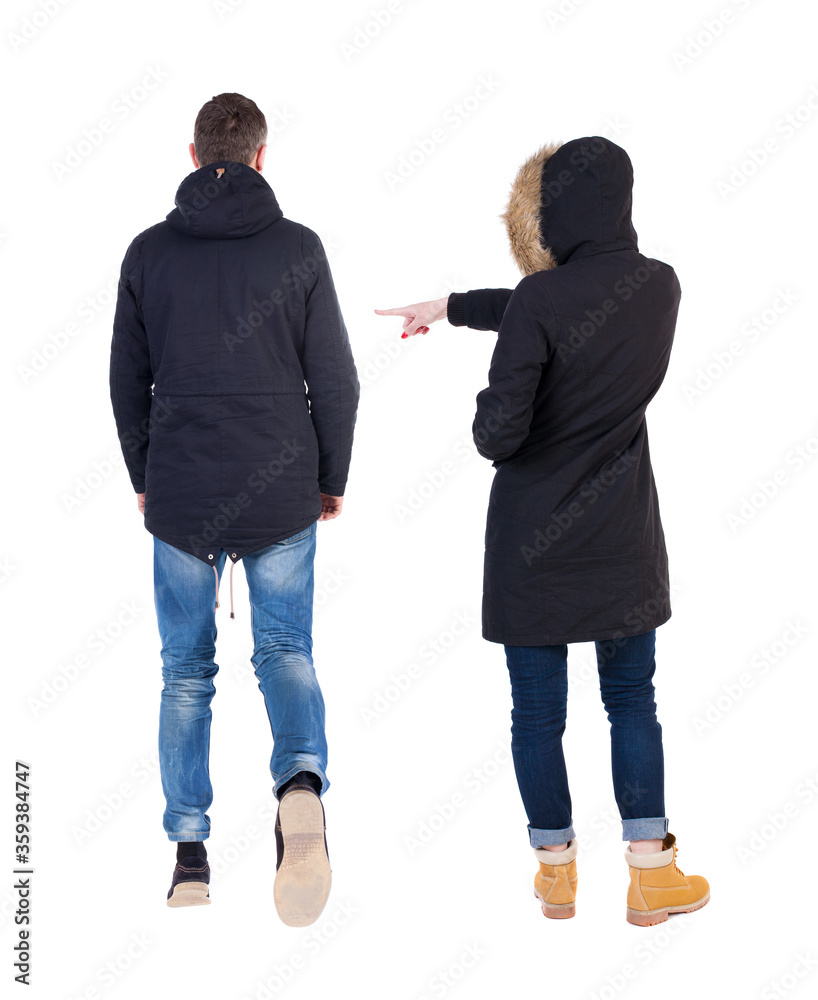 Back view of two pointing girl in winter jacket. Back view of two pointing girl in winter jacket.