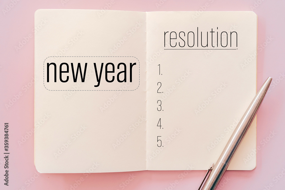 New year resolution on notebook with pen. New year resolution on notebook with pen.