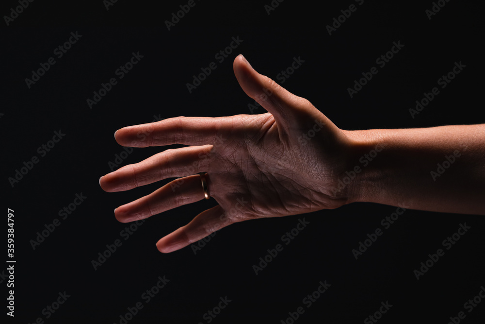 Palm of women’s hand on the black background.
