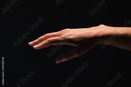 Hand on the black background. Three fingers visible.