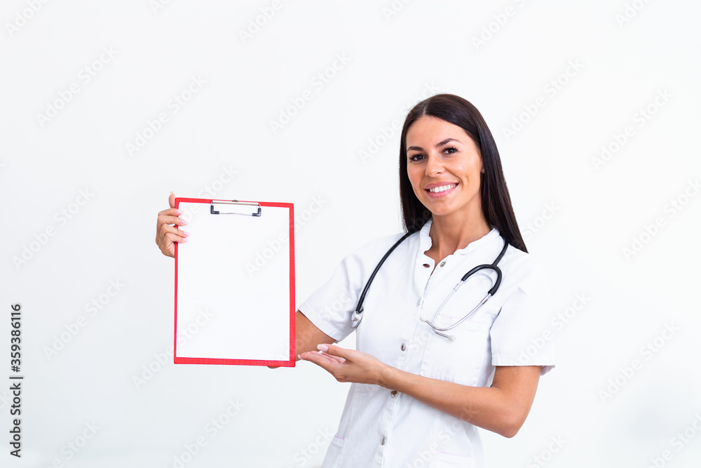 Portrait of beautiful woman doctor holding clipboard and looking at camera. Confident female doctor showing empthy clipboard . Doctor or nurse in labcoat and stethoscope in private clinic Portrait of beautiful woman doctor holding clipboard and looking at camera. Confident female doctor showing empthy clipboard . Doctor or nurse in labcoat and stethoscope in private clinic