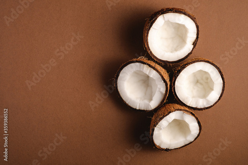 Coconut fruits on brown plain background, abstract food tropical concept, top view copy space