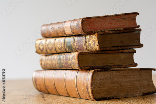 Old books on wooden table. Concept on the theme of history, nostalgia, old age and knowledge.