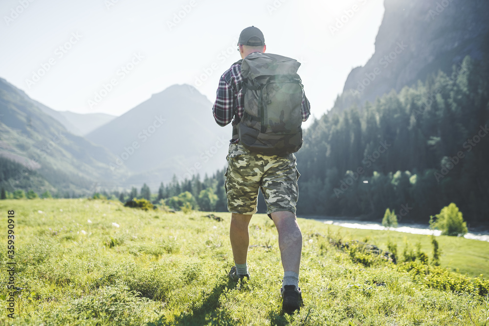 men with backpack hiking in the mountains