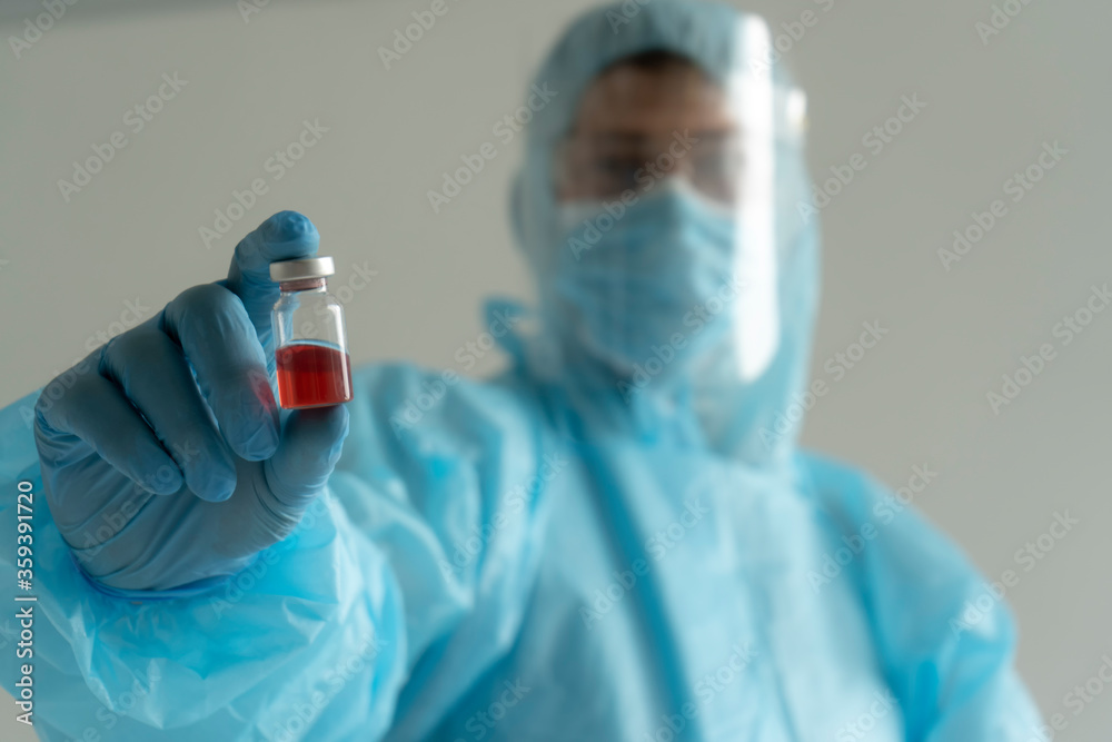 Doctor holds an ampoule with medicine