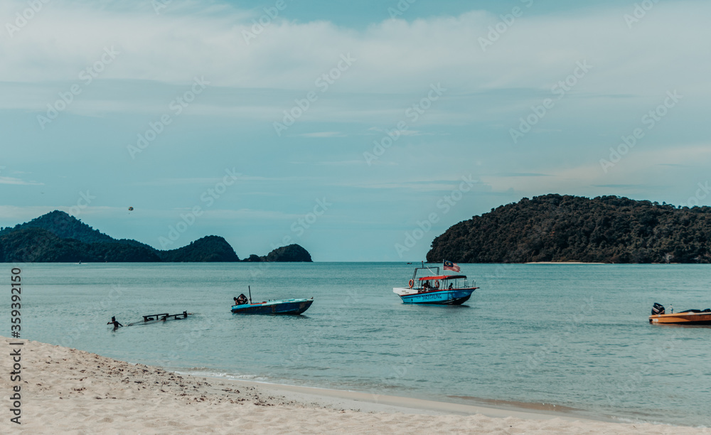 fishing boats on the blue color of beach