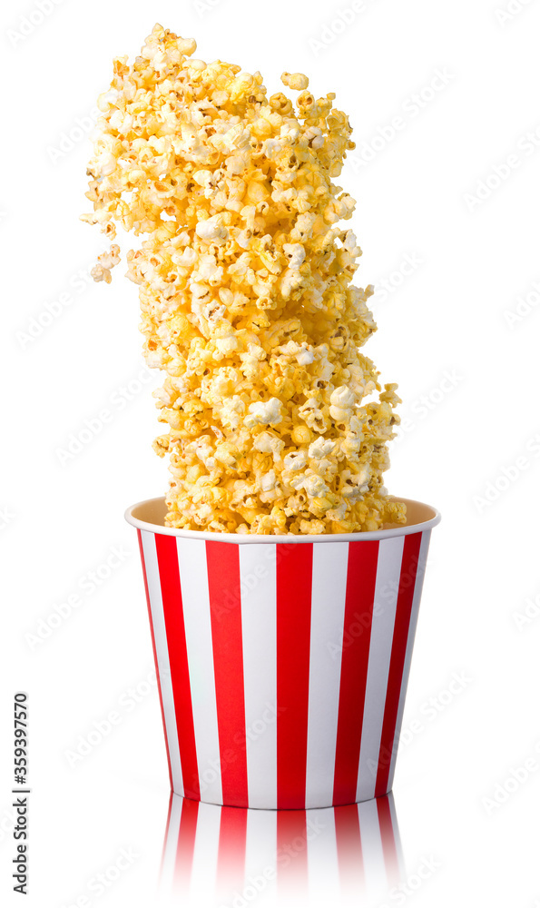 Flying popcorn from paper striped bucket isolated on white background Flying popcorn from paper striped bucket isolated on white background