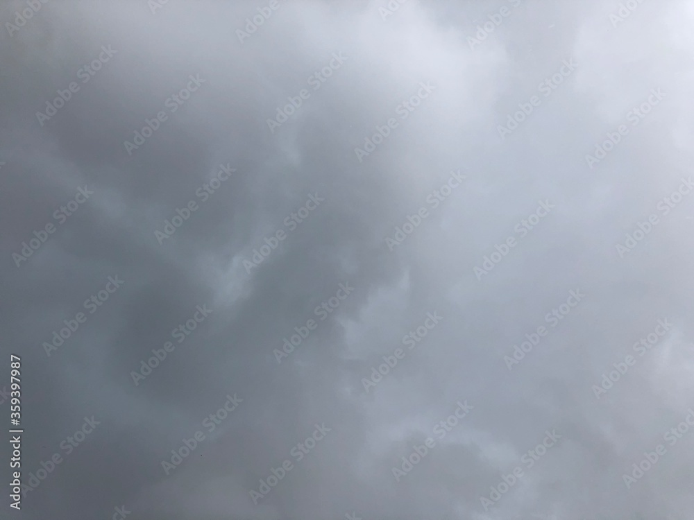 Beautiful dark rain storm clouds and white fluffy on sky,thunderstorm in dramatic sky,with lens flare.Climate cloudscape,selective focus.Weather tropical  summer squall.Time lapse footage. 