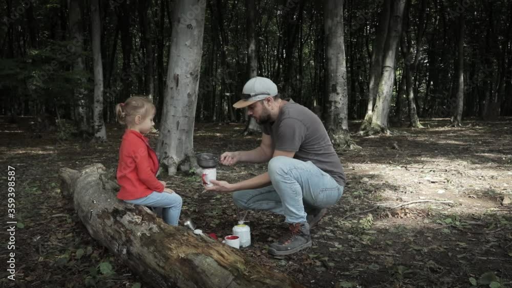 Having tea in outdoors. Father and daughter moment in nature Having tea in outdoors. Father and daughter moment in nature