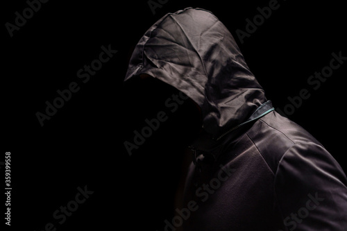 Portrait of Invisible man in the hood on black background. photo