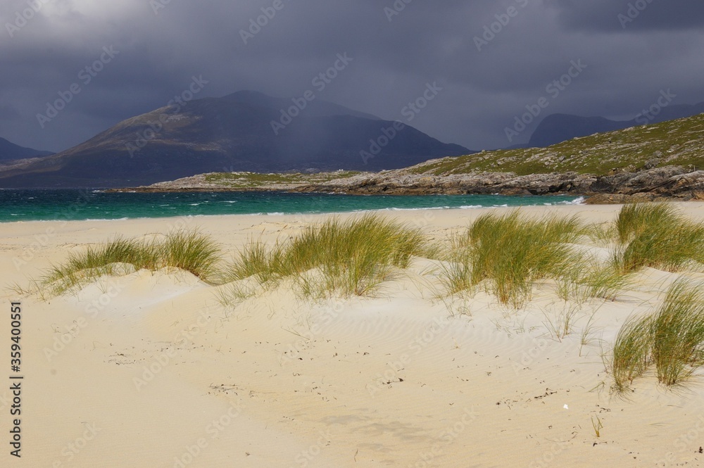 Luskentyre Beach on the Isle of Harris in the Western Isles of Scotland with an approaching storm and threatening clouds.