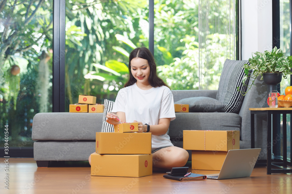 Asian women working with postal parcel, Selling online ideas concept