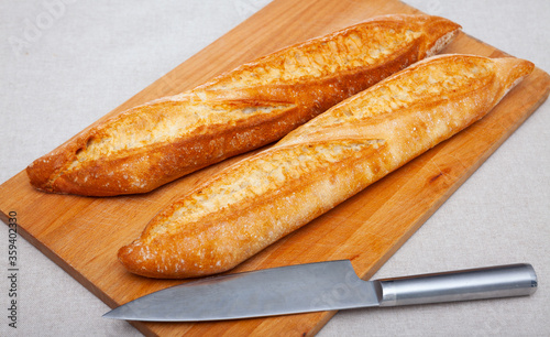 Closeup of appetizing fresh bread on wooden table photo