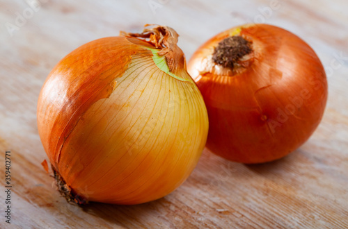Image of fresh onion bulbs on wooden background