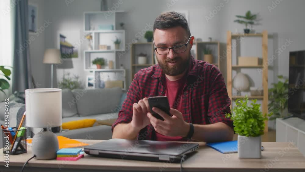 Man winner hold smartphone feel amazed overjoyed with mobile online bet bid app game win Man winner hold smartphone feel amazed overjoyed with mobile online bet bid app game win