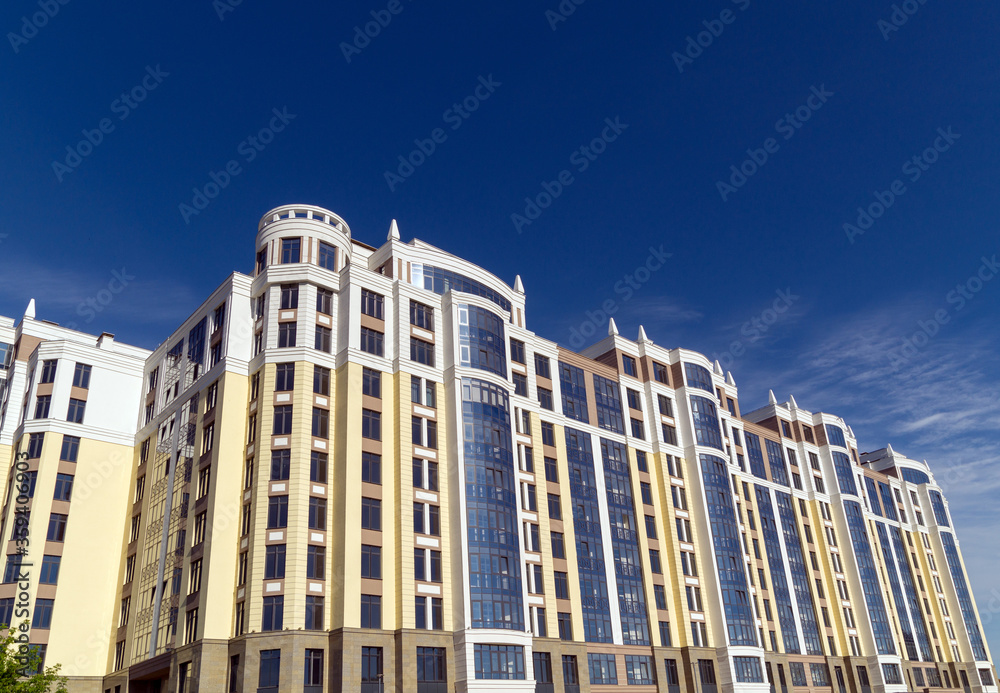 Multi-storey residential buildings against the blue sky in clear weather