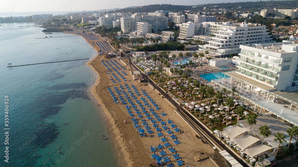 Aerial bird's eye view of Sunrise beach Fig tree, Protaras, Paralimni, Famagusta, Cyprus.The famous tourist attraction family bay with golden sand, boats, sunbeds, restaurants, water sports from above