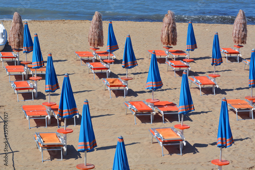 Prevention rules  for social distancing in bathhouse on a italian sandy beach. photo