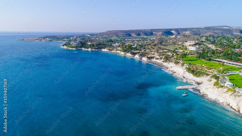 Aerial view of coastline and landmark big white chalk rock at Governor's beach,Limassol, Cyprus. Steep stone cliffs and deep blue sea waves next to Kalymnos fish restaurant and vasilikos power station