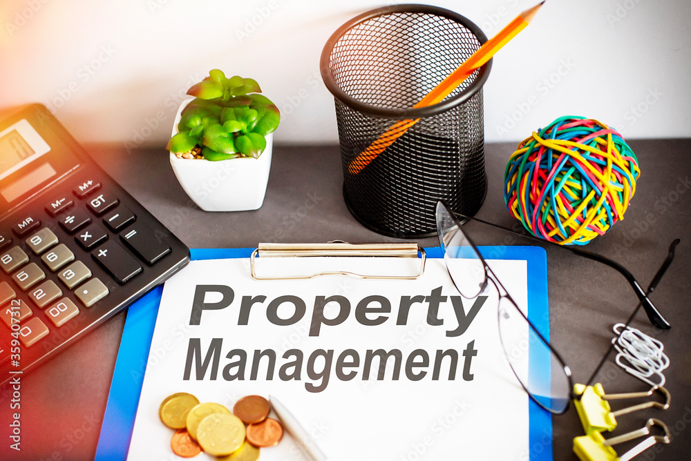 Property management written on paper with office tools