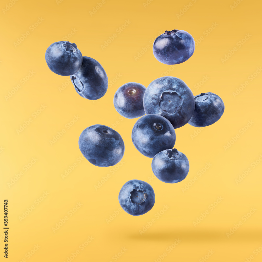 Fototapeta premium Fresh raw blueberries falling in the air.