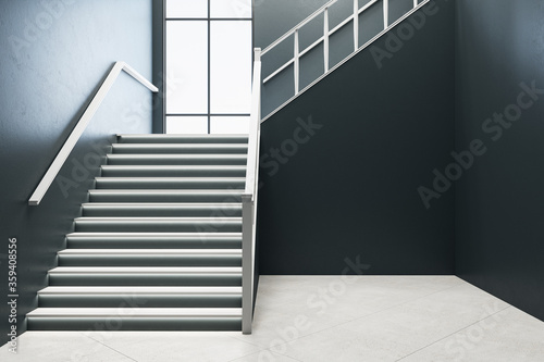 Modern concrete hall interior with stairs and window.