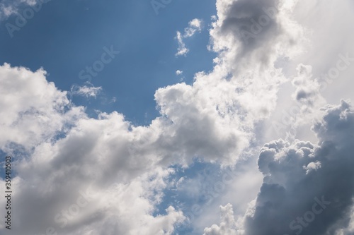 White and gray fluffy clouds in the blue sky. Beautiful sky background © kvitkanastroyu