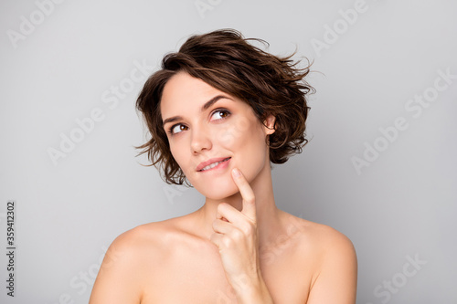 Closeup photo of beautiful naked lady bobbed short hairstyle look up empty space cheerful interested finger on chin dream of beauty procedure isolated grey color background
