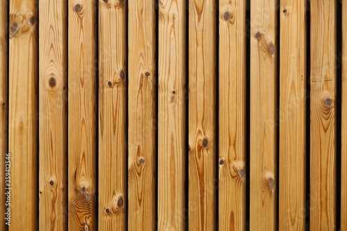 Brown wooden rough vertical planks with knots texture background