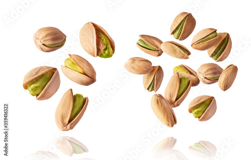Wallpaper Mural A set with Flying in air fresh raw whole and cracked pistachios  isolated on white background. Concept of Pistachios is torn to pieces close-up. High resolution image Torontodigital.ca