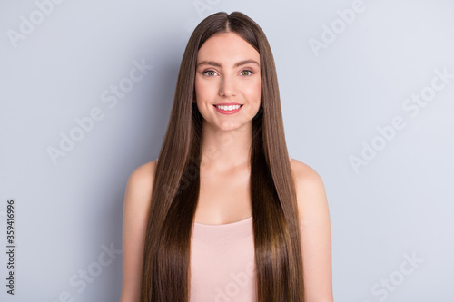 Photo of attractive cute perfect appearance model lady beaming smile demonstrating ideal neat long healthy hairstyle after salon wear beige singlet isolated grey color background