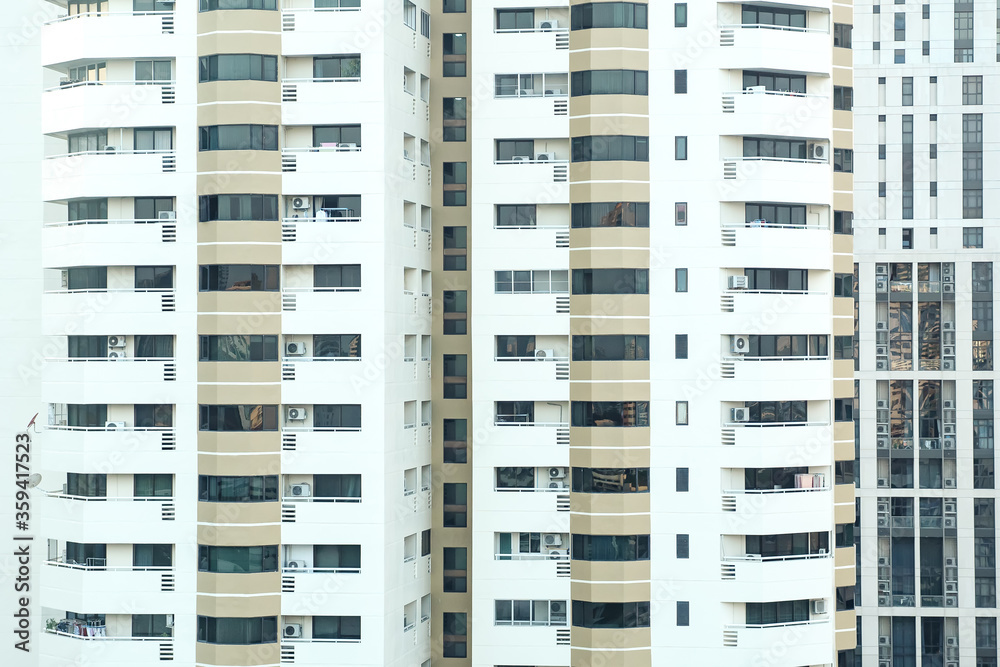 Tall, bright building with balconies and tinted windows. Tall, bright building with balconies and tinted windows.