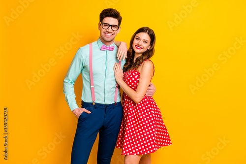 Photo pretty charming lady handsome guy prom party couple hugging photographing wear red dotted dress shirt bowtie retro clothes isolated yellow bright color background
