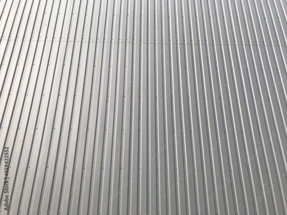 background texture of the facade of the building made of gray metal sheets background texture of the facade of the building made of gray metal sheets