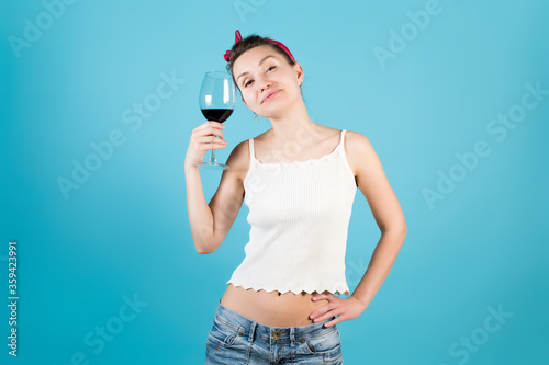 girl and a glass of red wine on a blue background