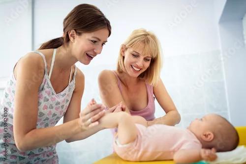 Obraz Lesbian couple women playing with their cute baby girl
