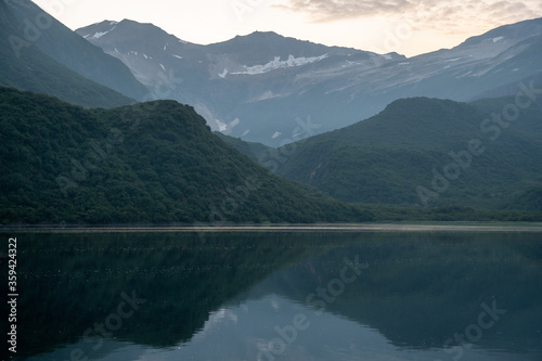 View of Geographic Harbor  Alaska at dusk with reflected mountains on a clear summer evening