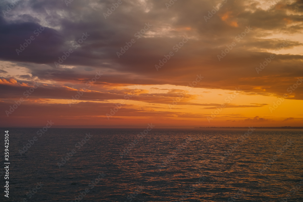 Multicolored red sky at sunset on the sea